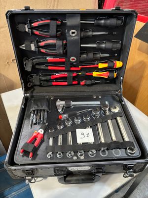 a tool case with tools in it sitting on top of a table