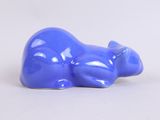 a blue cat statue sitting on a white surface