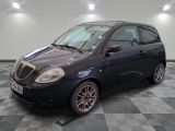 a picture of a small black car parked in a garage