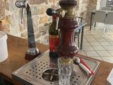 a coffee maker sitting on a table with a cup of coffee