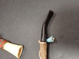 a picture of a knife and a pipe on a table