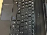 two laptops sitting side by side on a wooden table