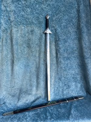 a close up of a sword laying on top of a blue cloth