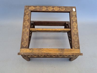 an old wooden step stool sitting on top of a white floor