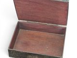a small wooden box that is open on a white surface