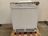 a white dishwasher sitting on a pallet in a room