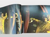 a book with a picture of a man in a yellow jacket