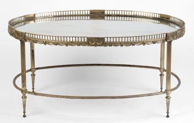 an antique brass coffee table with a glass top on a white background