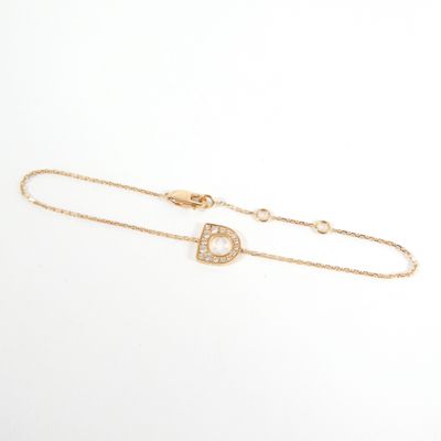 a gold bracelet with a diamond initial on it