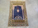 an oriental rug with a blue background and a gold border