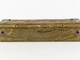 brass box with blue stones on it on a white surface