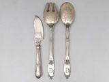 three spoons and a knife on a table