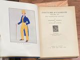 someone is holding a book with a drawing of a man in a blue suit