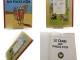 On voit plusieurs livres posés sur une surface blanche, dont la photo d'un homme à dos de chameau