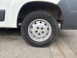 a white truck with a flat tire parked in a parking lot