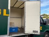 a truck that is parked in a lot with its door open