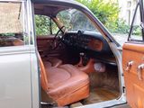 a car that is parked in the driveway with its door open