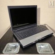 a laptop computer sitting on top of a black table