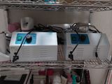 two machines that are sitting on a shelf in a room