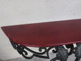 a red table with a leaf design on top of it
