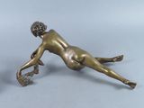 two bronze figurines of a woman and a man on the ground