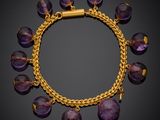 a gold bracelet with amethtites and amethtites