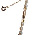 an image of a necklace with pearls and a gold clasp