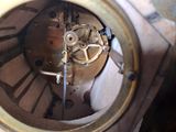 a close up view of a clock with a metal case