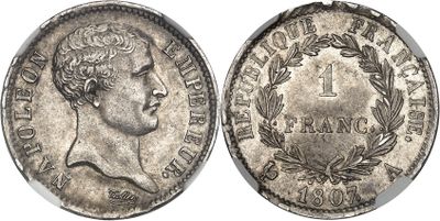 a silver coin with an image of a man ' s head on it