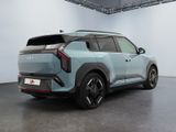 the rear end of a light blue suv parked in a garage