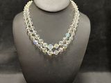 the necklace is made of glass beads and has a silver clasp