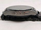 a close up of a watch on a white surface