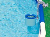 an above ground pool with a hose attached to the side of it