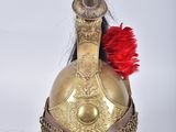 un casque doré orné d'une plume rouge