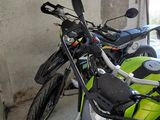 two motorcycles parked next to each other in a garage