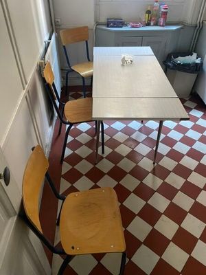 several chairs and a table in a small room with a red and white checkered floor