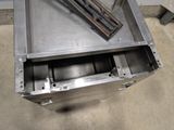 a metal box that has a bunch of metal items inside of it
