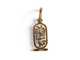 a gold pendant with an egyptian symbol on it