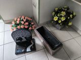 a vase of flowers sitting on the floor next to a door