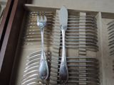 a lot of forks and spoons that are in a drawer