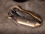 a picture of a couple of exhaust mufflers laying on the ground