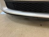 a close up of the front bumper of a white car