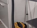 a vacuum that is sitting on the floor in the kitchen