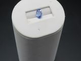 a white box with a blue stone inside of it