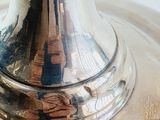 a silver vase that is sitting on a table