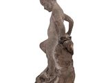 statue of a boy sitting on a rock with his hands on his knees