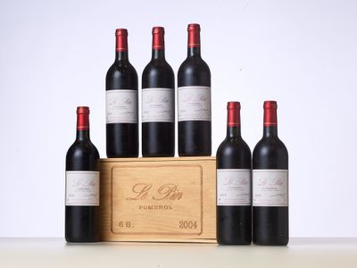 six bottles of red wine in a wooden crate on a table