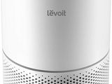 a white air purifier sitting on top of a white table