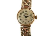an image of a woman ' s wrist watch with a gold bracelet