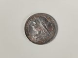 a silver coin with a woman ' s face on it